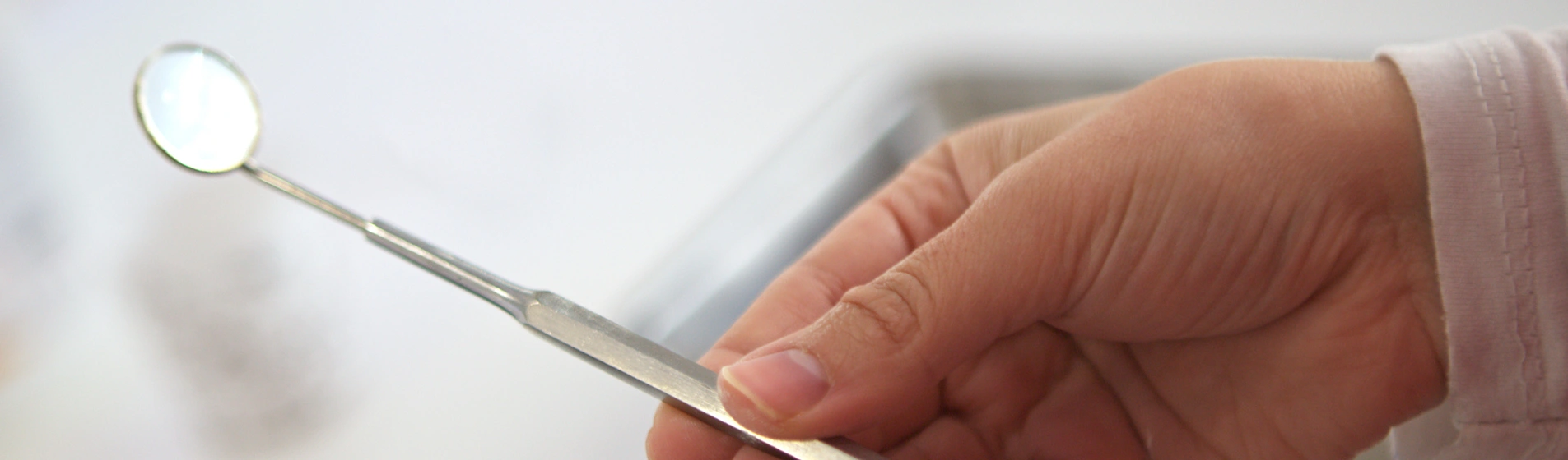 Dentist performing a routine dental checkup and cleaning on a patient