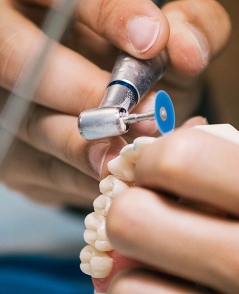 Dentist using a drill during a general dentistry service at The Hamptons Dentist in Westhampton Beach NY